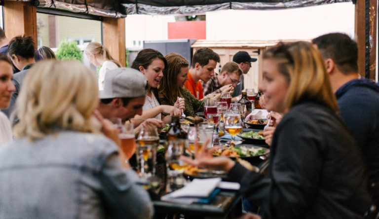 A group of people sharing a meal at a restaurant table.