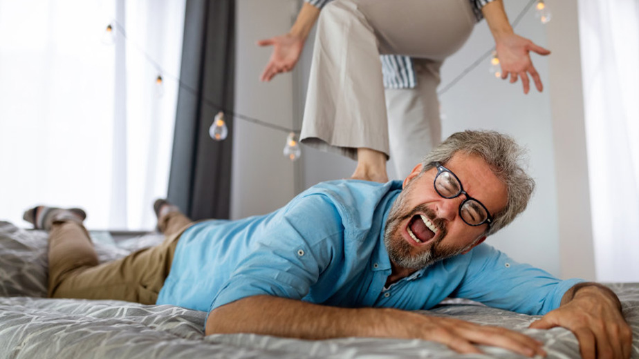 Senior couple having a sensual forplay for bdsm, female dominance sex