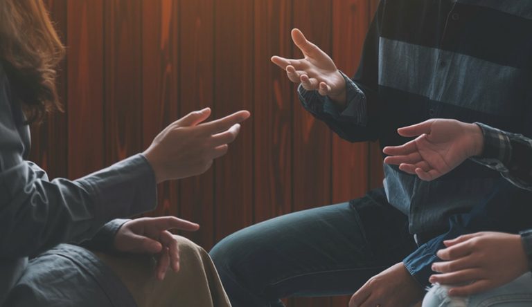 a group of people sitting together talking