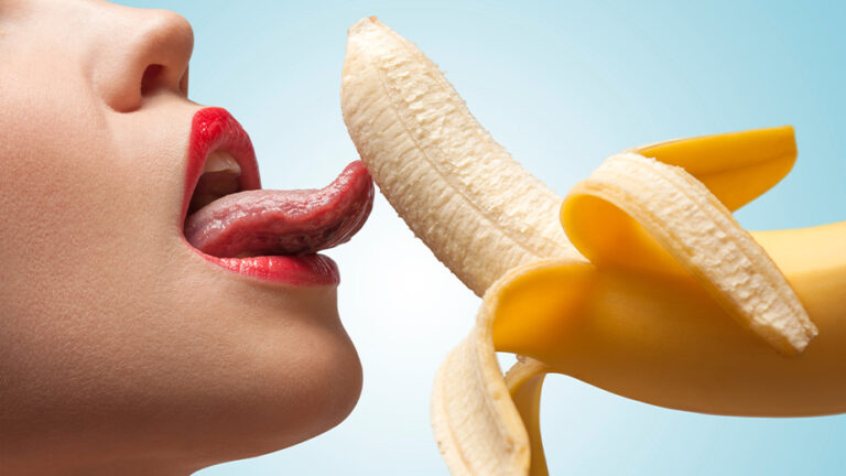 a woman licking a banana
