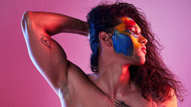 Genderqueer person with tats and facepaint